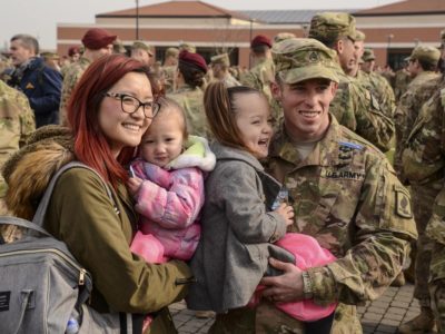 "My Daddy is the greatest!" A proud family congratulates a paratrooper who has just been awarded his Expert Infantryman Badge, as she is held at a ceremony at the 173rd Airborne Brigade.