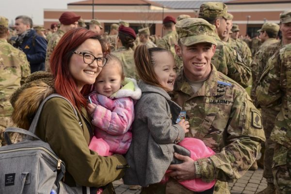 "My Daddy is the greatest!" A proud family congratulates a paratrooper who has just been awarded his Expert Infantryman Badge, as she is held at a ceremony at the 173rd Airborne Brigade.