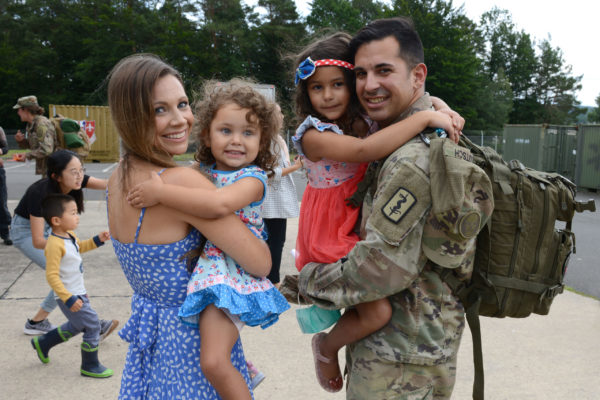 Soldier poses with family