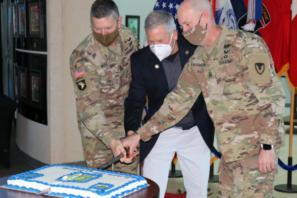 soldiers cut a cake with a saber