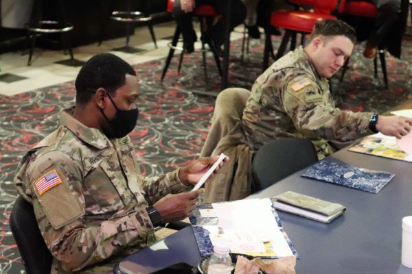 Soldiers sit at table.
