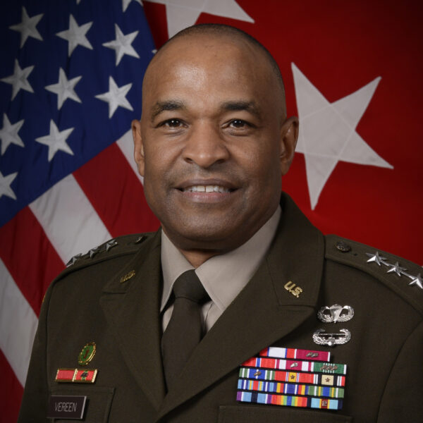 Official military portrait of Lt. Gen. Kevin Vereen, who is pictured in his dress uniform in front of an American flag and red flag with three white stars on it.