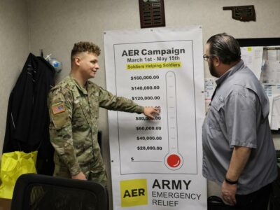 Sgt. Zack Mason, 2nd Battalion, 6th Air Defense Artillery, 30th ADA Brigade, discusses the upcoming kickoff of the AER campaign with Daniel Farrell, AER assistant and campaign coordinator, Army Community Service. The campaign kicks off with a bowling tournament at the Twin Oaks Bowling Center March 1, 2023. (Photo by Monica Wood)