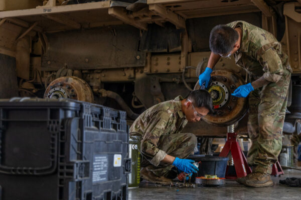 Pfc. Duc Dao and Spc. Ralvin Dalere, wheeled vehicle mechanics assigned to 2nd General Support Aviation Battalion, 4th Combat Aviation Brigade, 4th Infantry Division, conducts maintenance to a Heavy Expanded Mobility Tactical Truck during a Oshkosh Defense led training class at Fort Carson, Colo., Oct. 17, 2023. Mechanics contribute to the mission success so training to upkeep military vehicles is an important task. (U.S. Army photo by Sgt. Woodlyne Escarne)